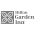 Hilton Garden Inn logo featuring a square icon with four stylized leaves and serif typography.